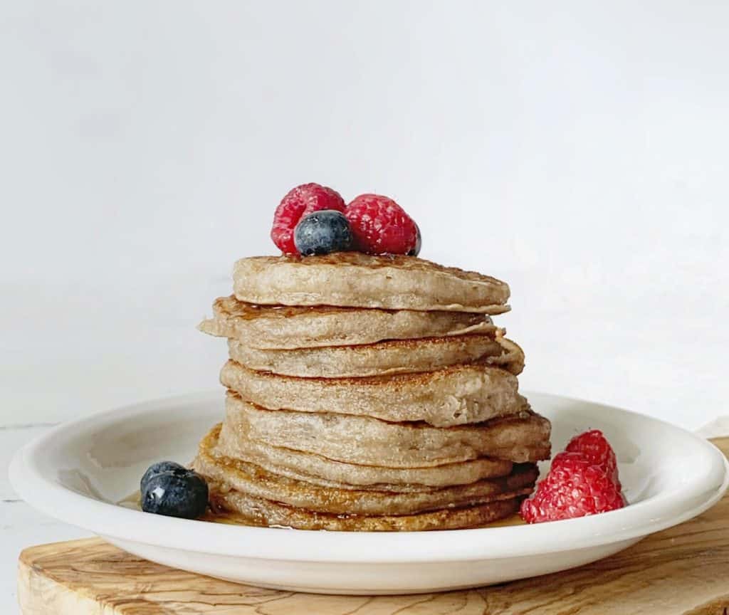 Stack of AIP sourdough pancakes (paleo, vegan) with blueberries, raspberries 