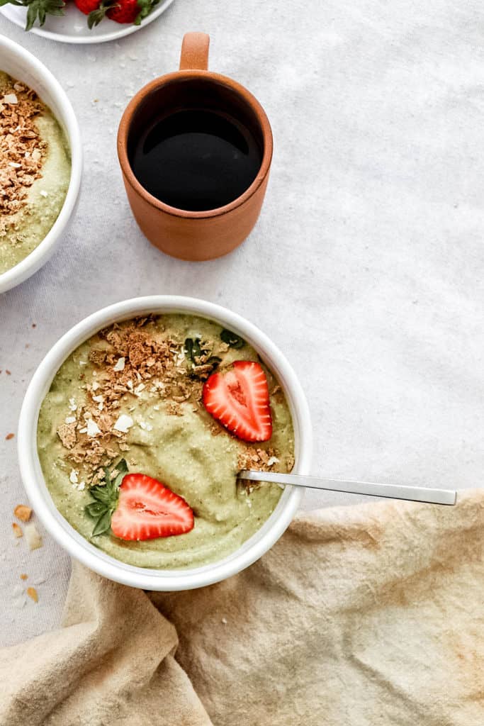Strawberry Avocado Smoothie Bowl with a cup of coffee