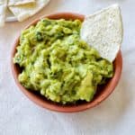 Bowl of Guacamole with Preserved Lemons (AIP, paleo, vegan) with grain free tortilla chips