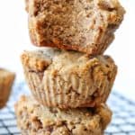 Three AIP Banana Spice Muffins stacked on top each other on top a cooling rack