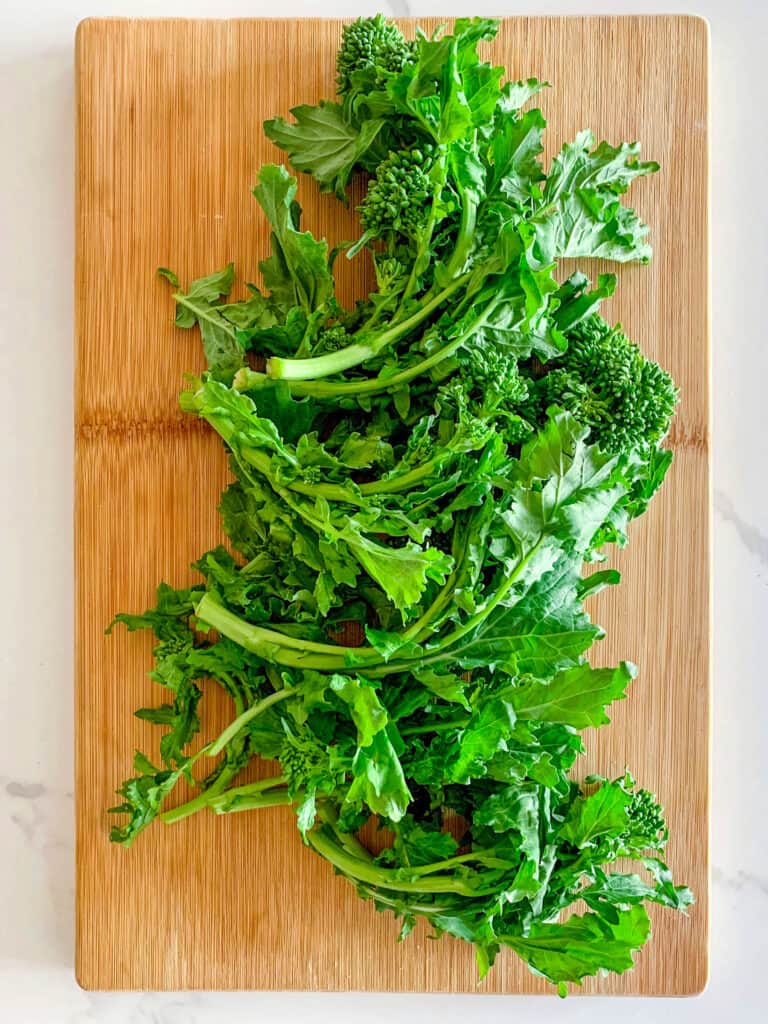 wooden chopping board with broccoli rabe