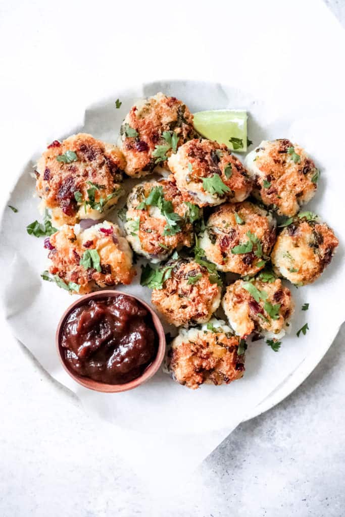 Plate of AIP Cod Fritters with lime wedge and tamarind sauce