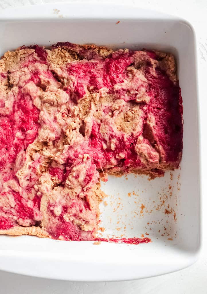 close up image of white baking dish with strawberry AIP baked panca with one square removed