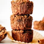 three zucchini muffins stacked on top each other