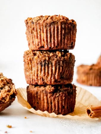 three zucchini muffins stacked on top each other