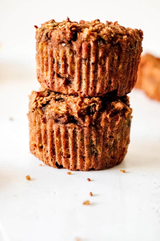 two zucchini muffins stacked on top each other