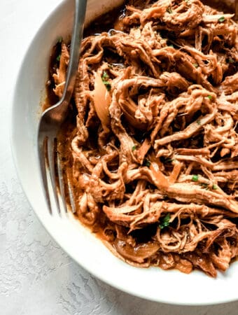bowl with pulled pork and a large fork