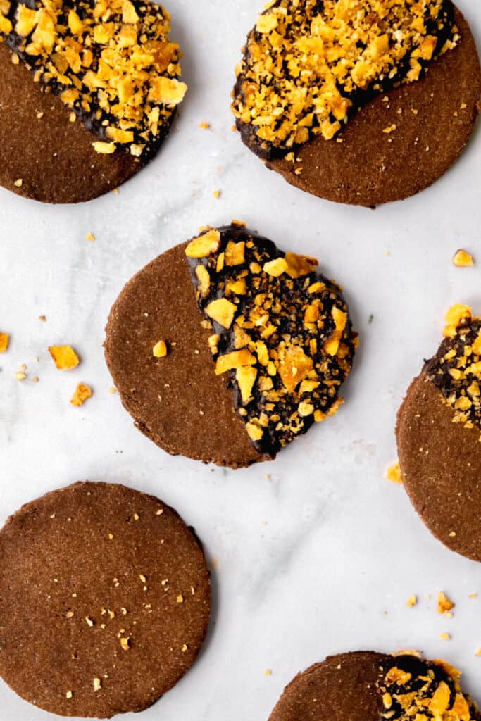 carob cookies and crushed plantain chips on a marble backdrop