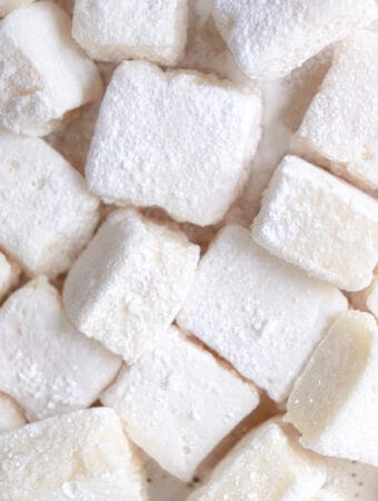 cream colored marshmallows dusted in tapioca starch on a beige plate