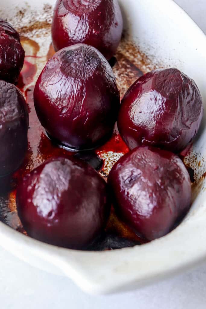 a white oval platter with roasted beets
