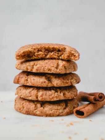 Stack of five Dairy-free Paleo AIP Snickerdoodle cookies with two cinnamon sticks