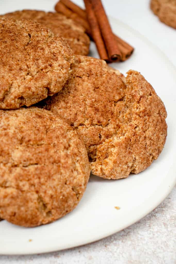 A plate with dairy-free, paleo/AIP snickerdoodles and two cinnamon sticks