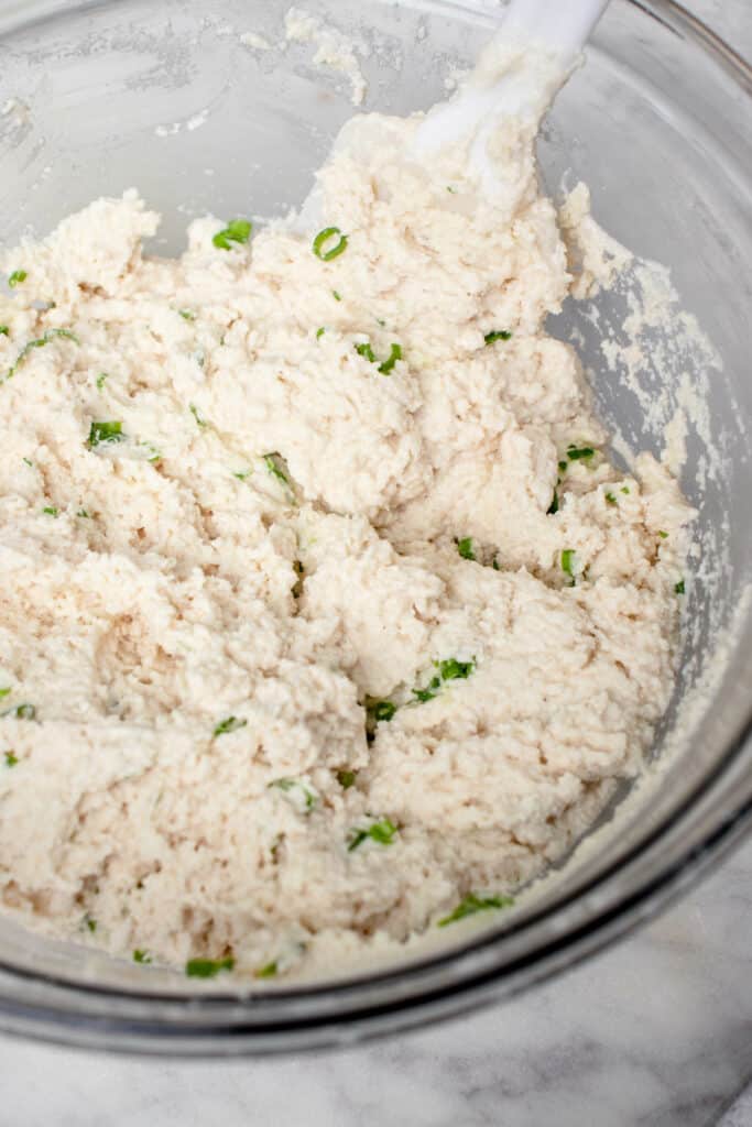 Mixing the dough for the vegan gluten free biscuits with chives