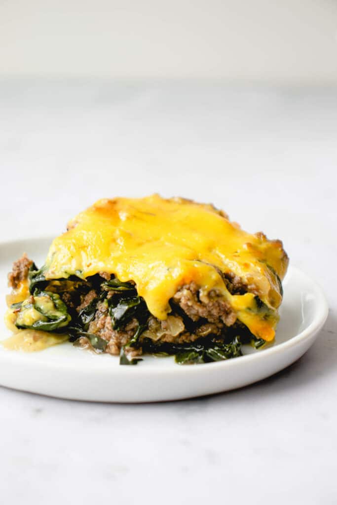 slice of dairy-free beef and kale casserole on a small white plate