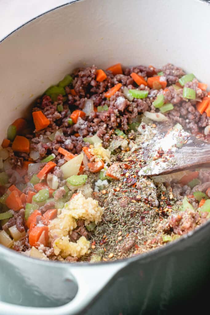 Mirepoix, ground meat and seasonings in a stockpot