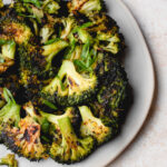 Baked smashed broccoli on a plate