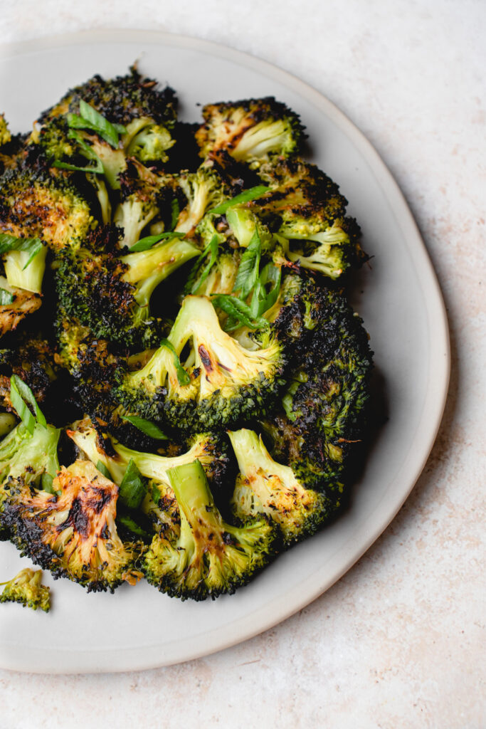 Baked smashed broccoli on a plate