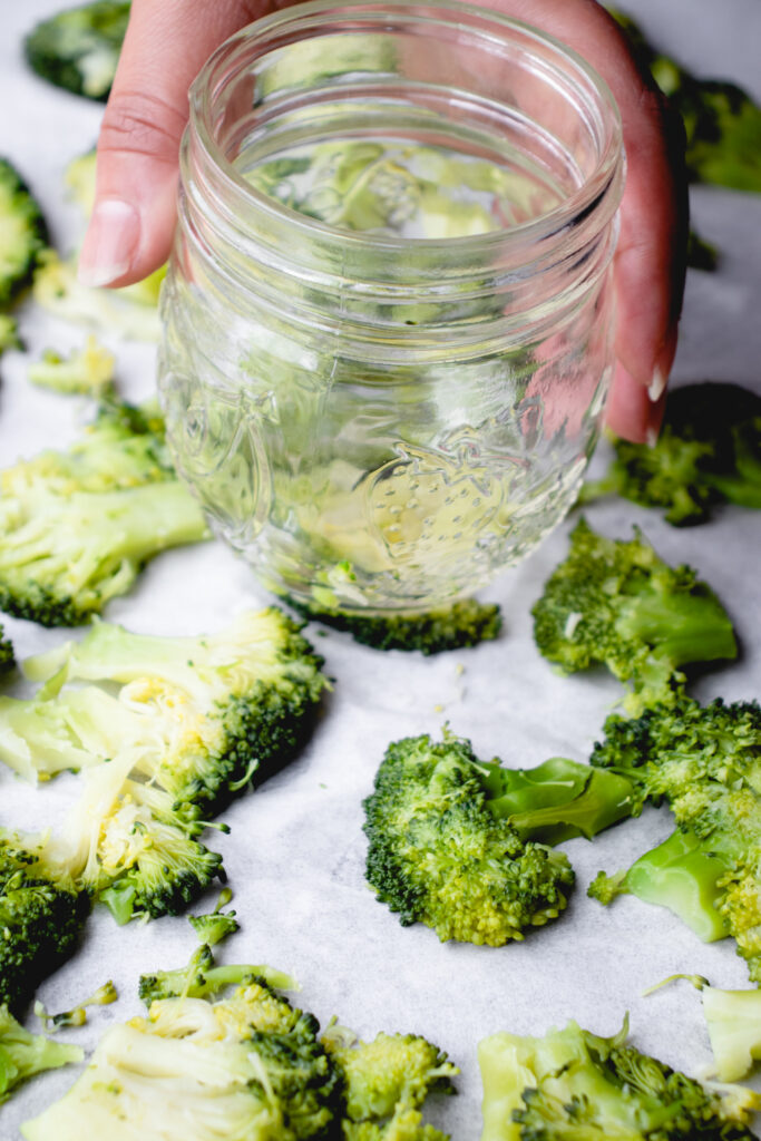 Smashing broccoli with a mason jar