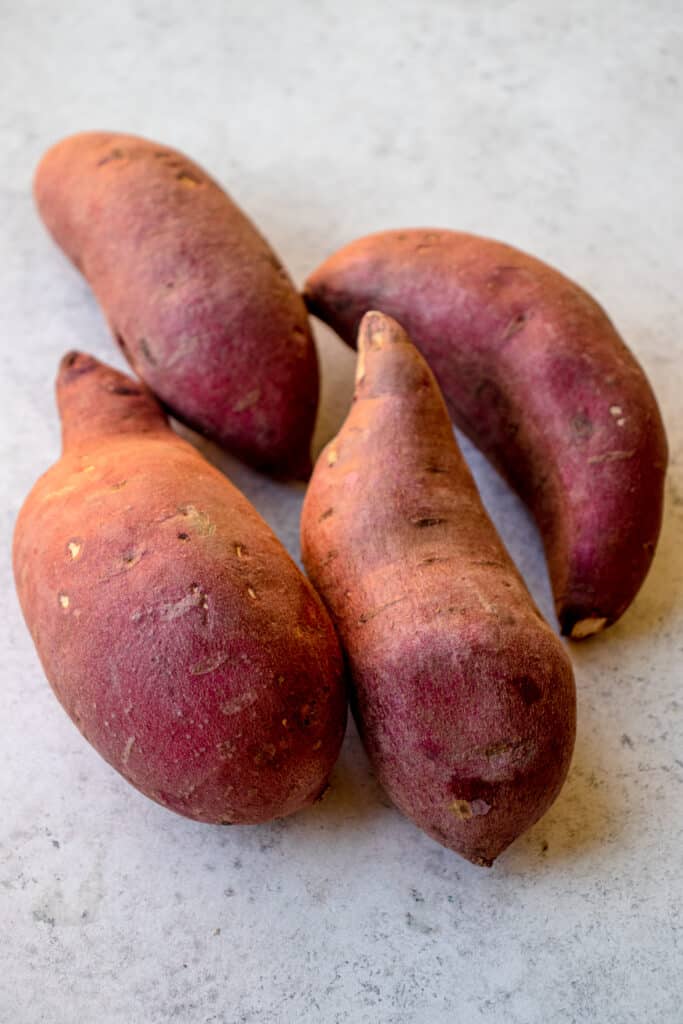 4 Japanese sweet potatoes on a grey background