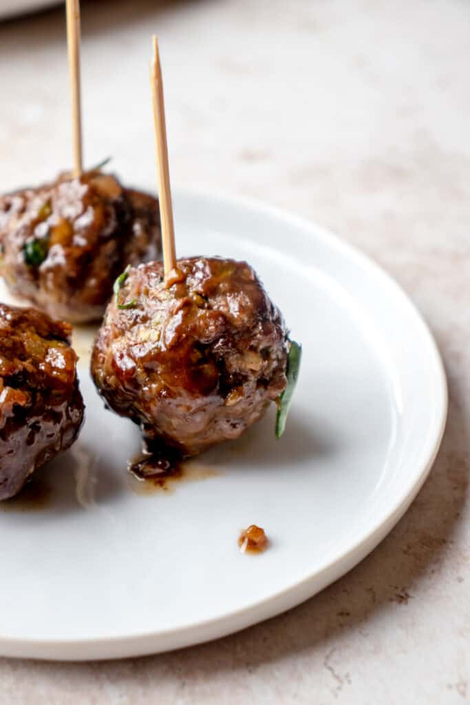 Meatballs with toothpicks on an appetizer plate