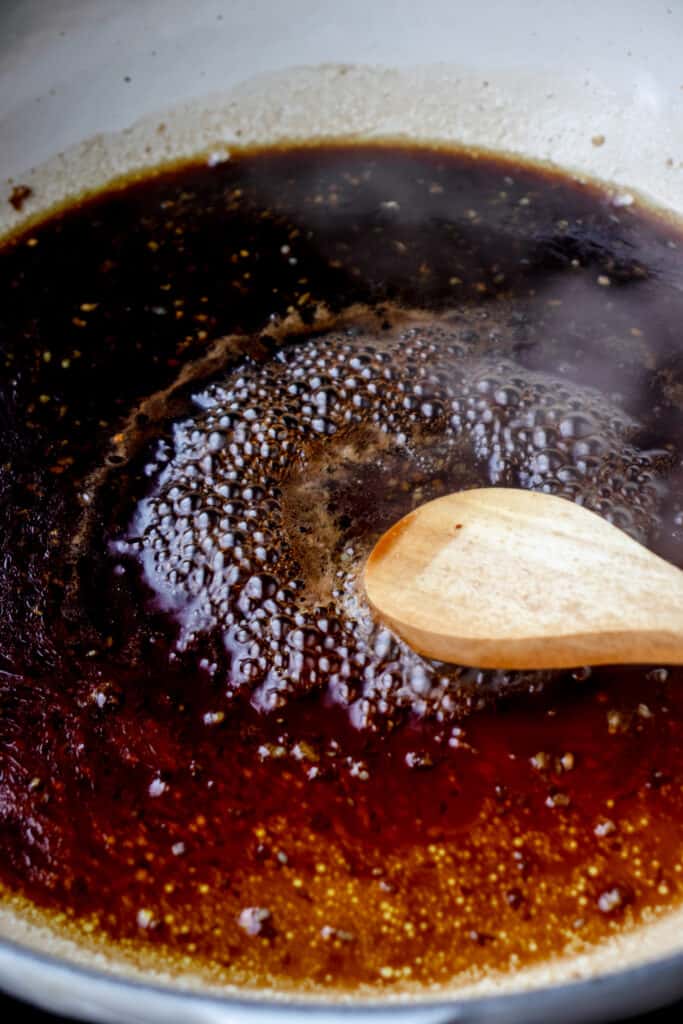 Process shot of honey garlic sauce being made in skillet.