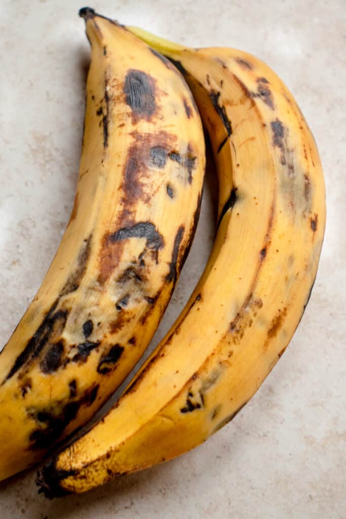 two sweet ripe plantains with yellow exterior and dark black spots