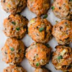 Rows of baked Egg-free AIP/Paleo Breakfast Meatballs on parchment paper.