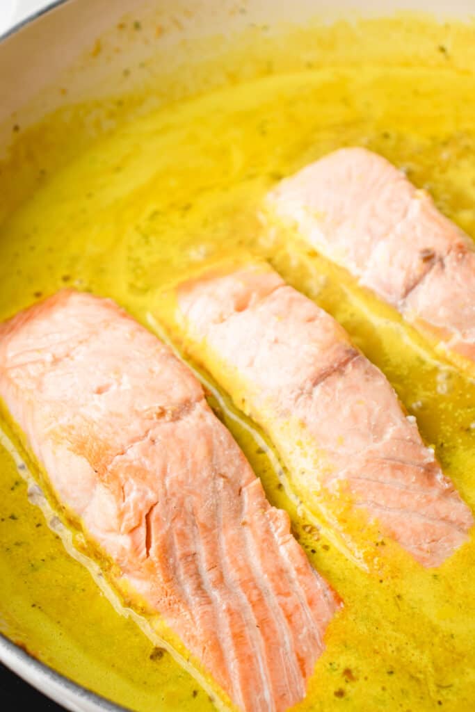 Salmon filets returned to pan in the curry sauce.