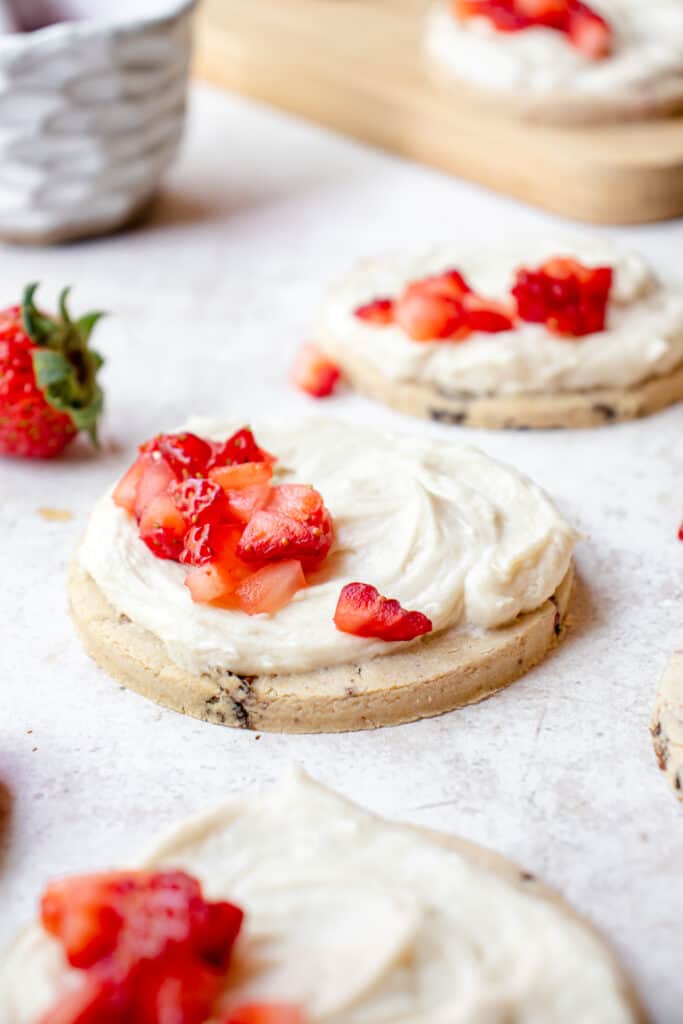 Strawberry cookies with icing and chopped fresh strawberries.