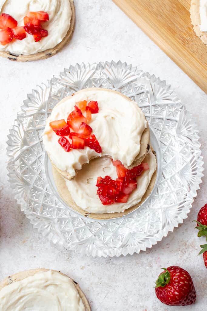 two strawberry cookies on a glass plate