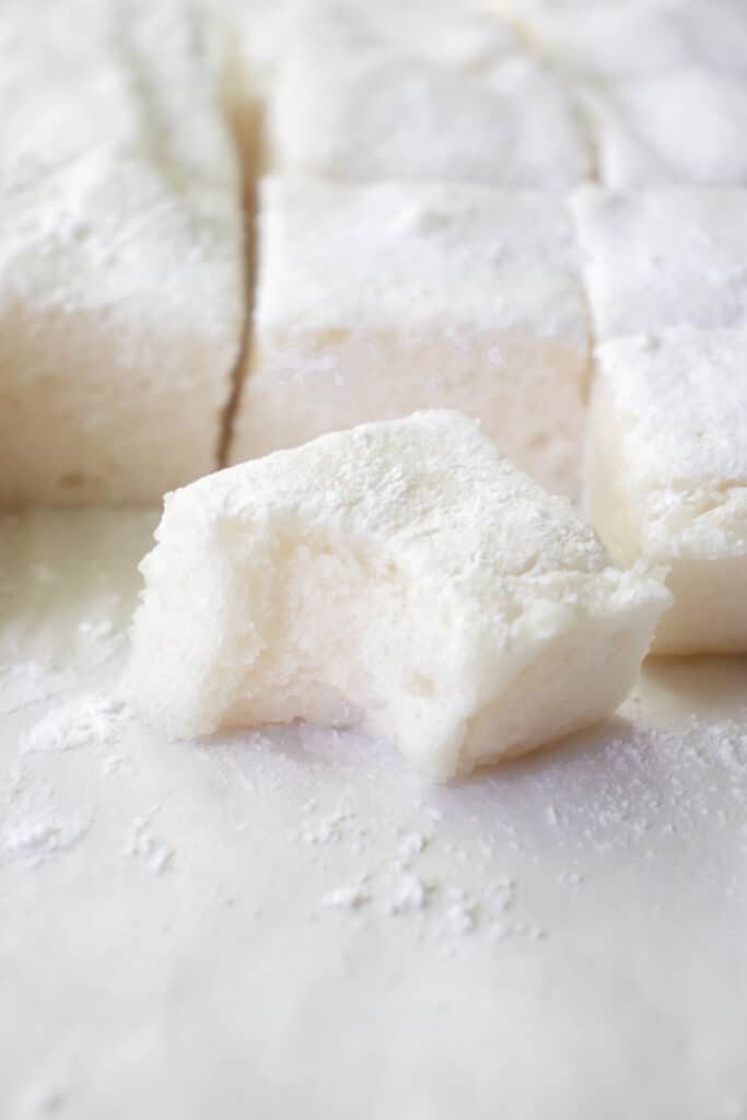 A close up shot with cut Gluten Free Marshmallows. The marshmallow in the front is bitter, to show the texture inside.