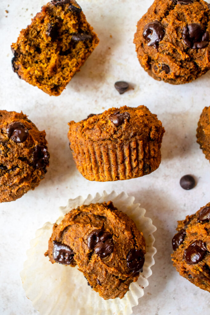 Pumpkin Chocolate Chip Muffins on an off white background.