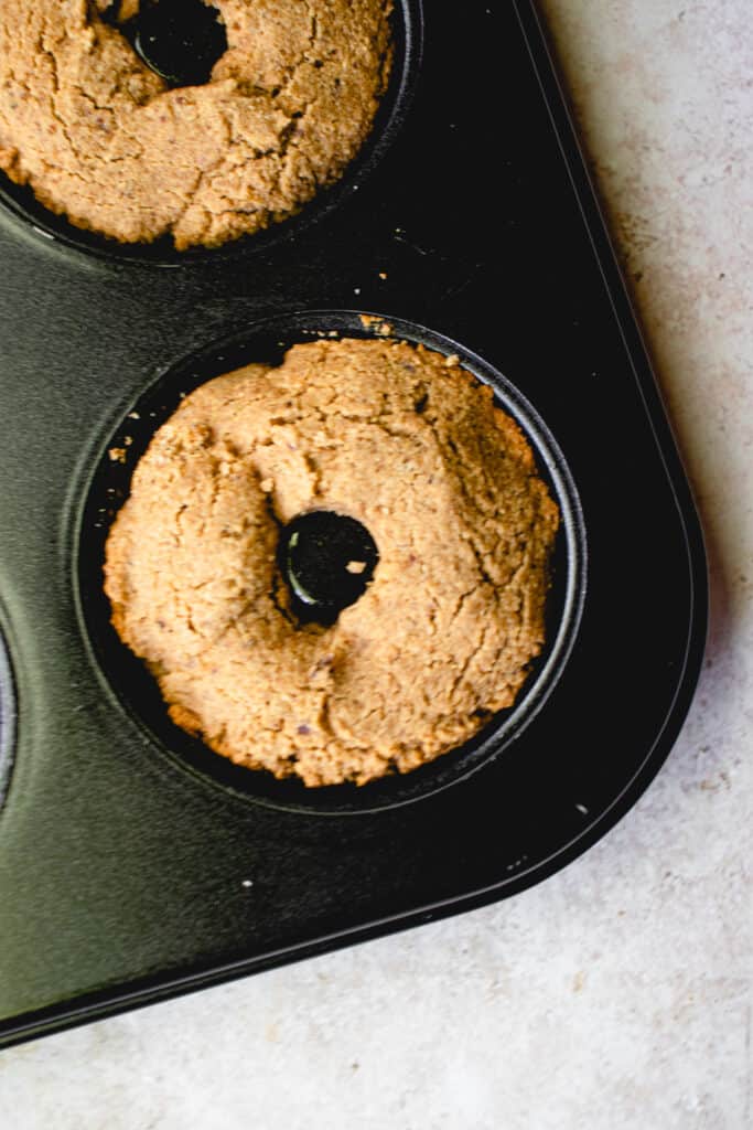 Baked apple cider donuts in a donut pan.