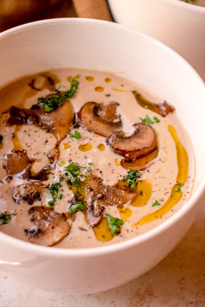 Close up, bowl of Gluten-Free Dairy-Free Cream of Mushroom Soup with optional garnishes.