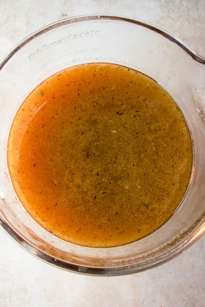 Overhead shot of large glass bowl with strained Gluten-Free Bone Broth.