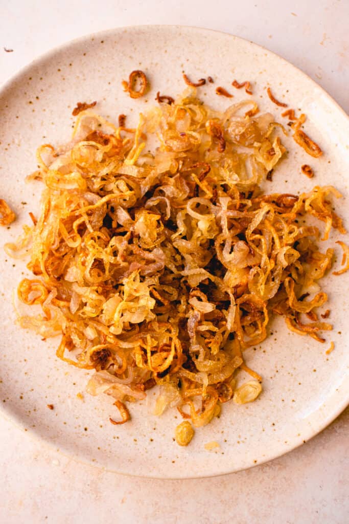 A plate with crispy, golden brown fried shallots.