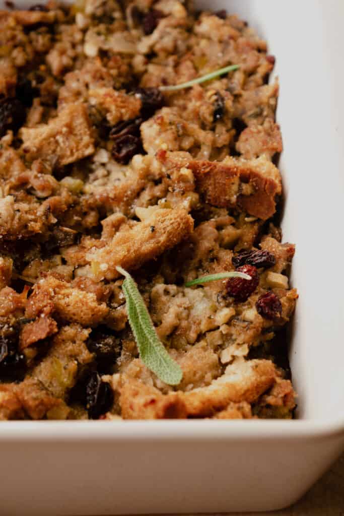 Close up of Gluten-Free Stuffing with raisins in a baking dish.