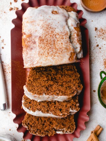Overhead shot of a Gluten-Free Gingerbread Loaf topped with a coconut glaze.