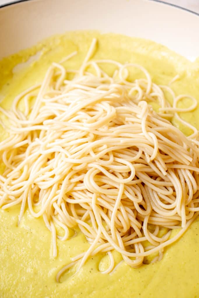carbonara sauce in skillet topped with grain-free spaghetti