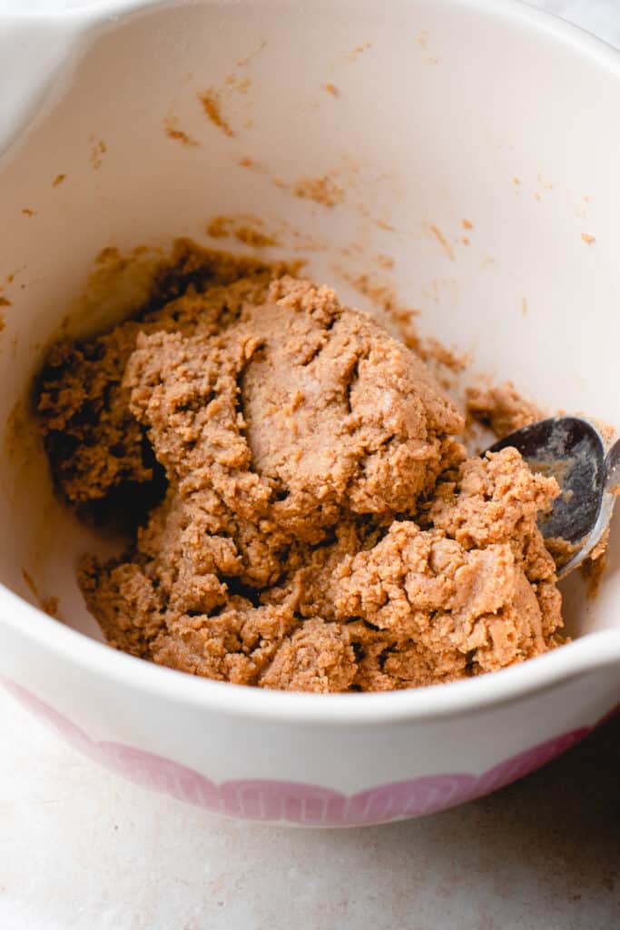 Easter egg tahini-almond butter mixture combined in a large bowl with a spoon.