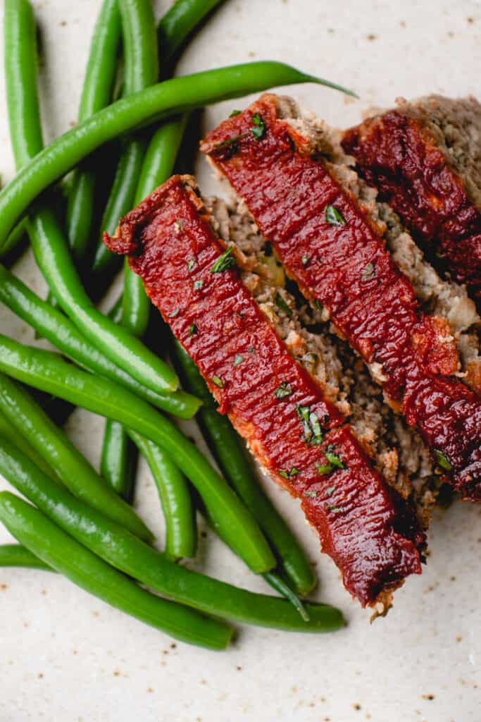 three slices of Dairy-Free Gluten-Free Meatloaf and green beans.