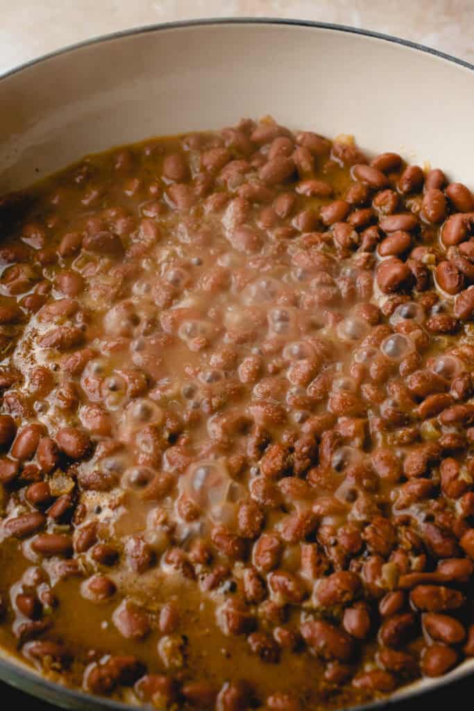 Pinto beans brought to a boil in the skillet.