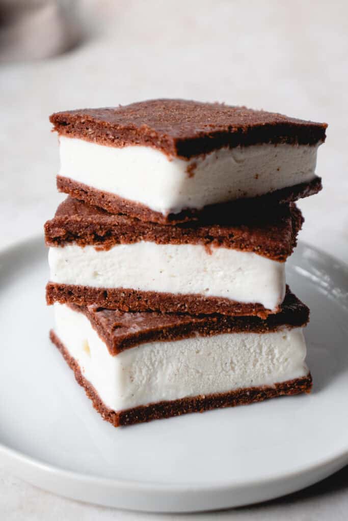 A stack of 3 Gluten-Free Dairy-Free Ice Cream Sandwiches atop a small white dessert plate.