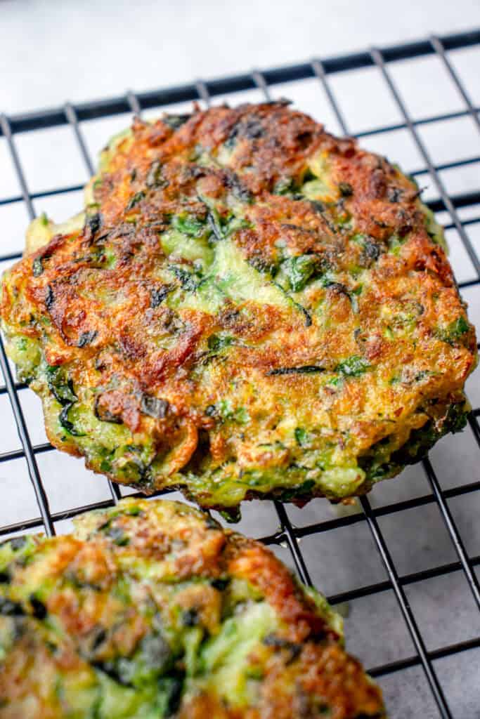 Two Gluten Free Zucchini Fritters on a wire cooling rack.
