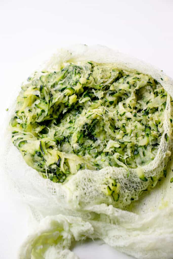 The dried, flat zucchini in a cheesecloth after squeezing out excess moisture.