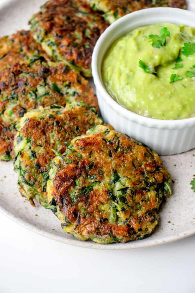 A plate with Gluten Free Zucchini Fritters with Avocado Salsa