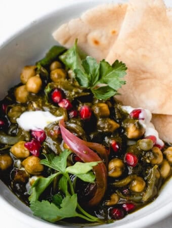 A bowl with Kale and Chickpea Shakshuka and cassava tortillas.