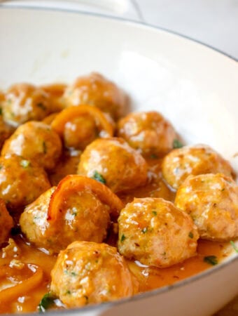 Skillet with meatballs tossed in lemon honey glaze.
