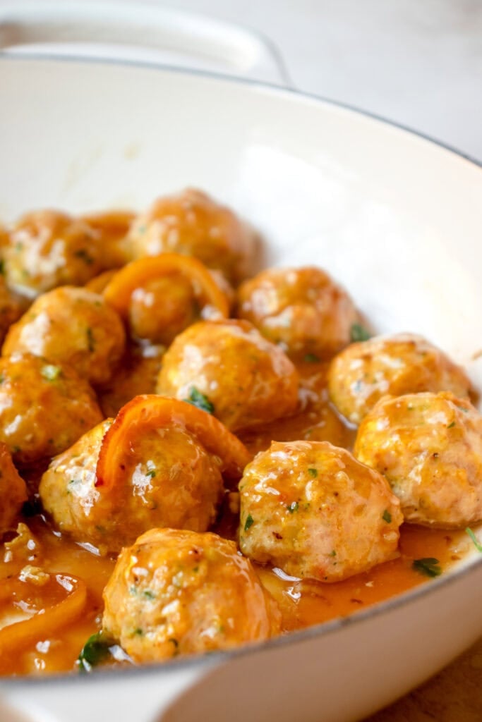 Skillet with meatballs tossed in lemon honey glaze.
