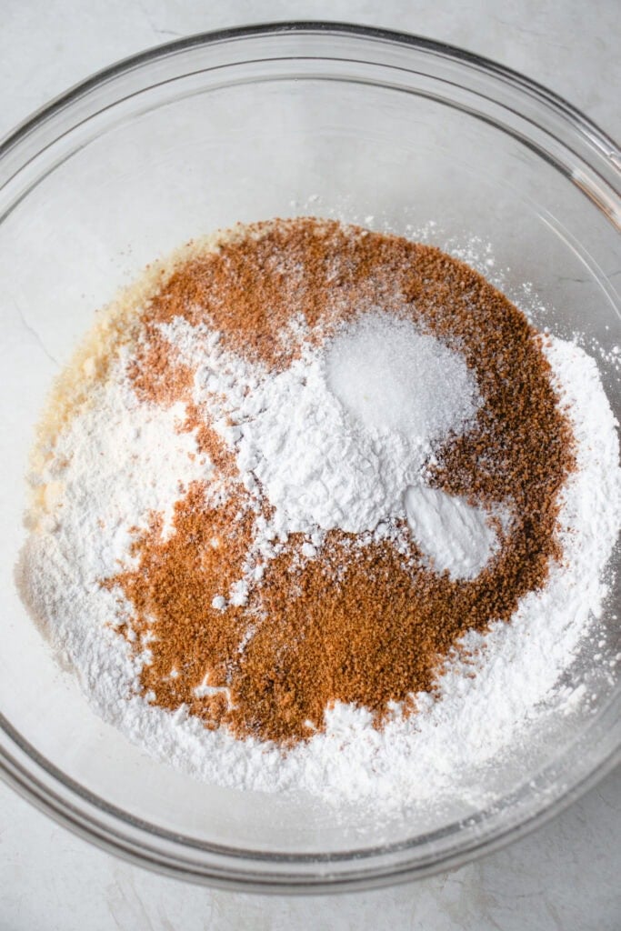 Large glass bowl with dry ingredients.